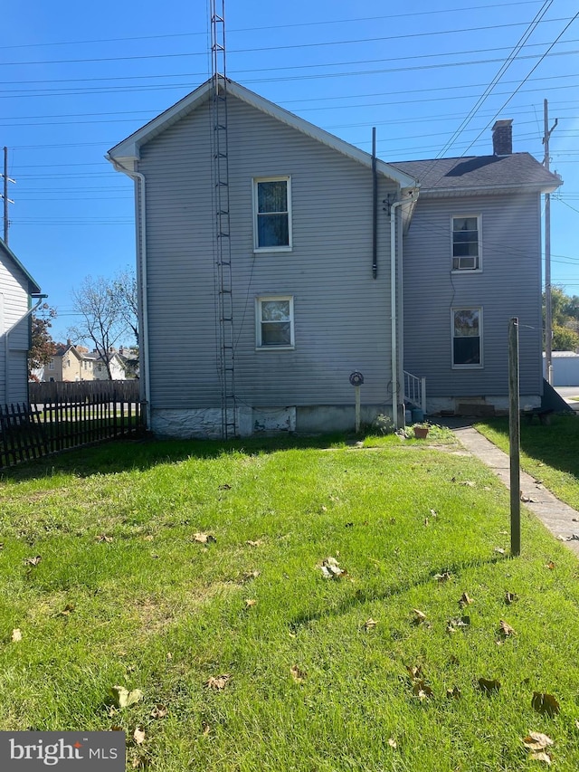 back of house with a lawn