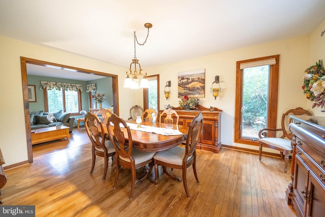 dining room with an inviting chandelier and light hardwood / wood-style flooring