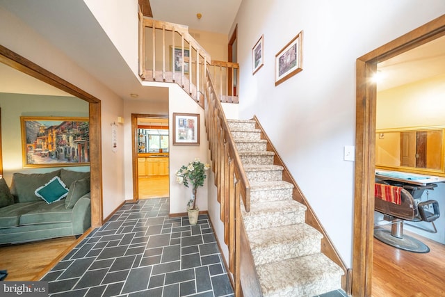 staircase featuring wood-type flooring