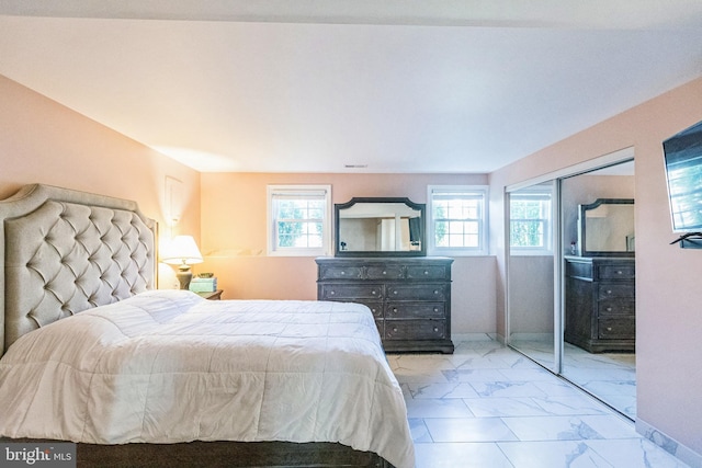 bedroom with visible vents, marble finish floor, baseboards, and multiple windows