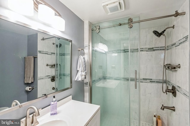 full bathroom with vanity and a shower stall