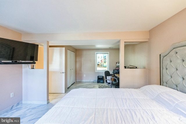 bedroom featuring baseboards and marble finish floor