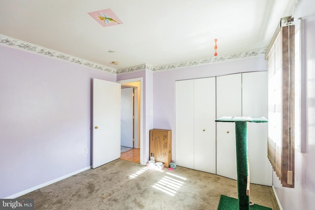 unfurnished bedroom featuring carpet and a closet