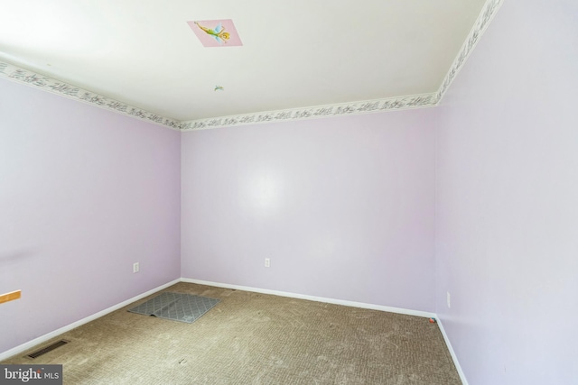 unfurnished room featuring baseboards, carpet flooring, and visible vents