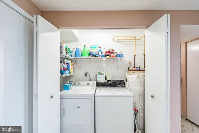 washroom featuring washer and clothes dryer, marble finish floor, and laundry area