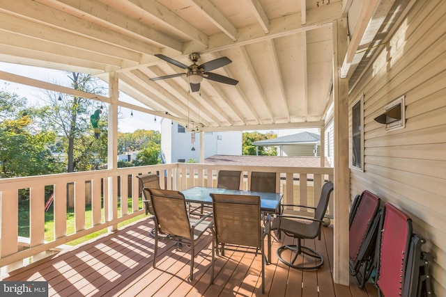 wooden terrace featuring a ceiling fan and outdoor dining area
