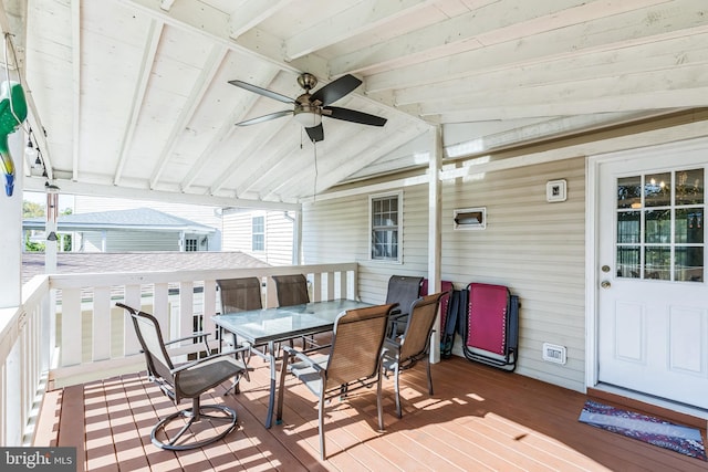 wooden terrace featuring outdoor dining area and ceiling fan