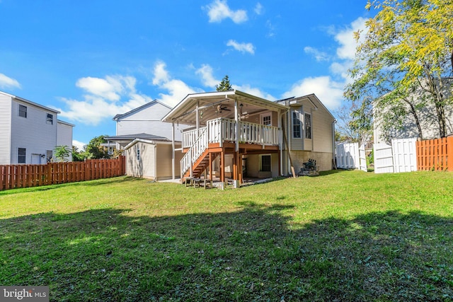 back of house featuring a fenced backyard, a ceiling fan, stairs, a deck, and a yard