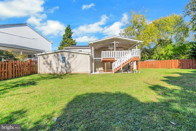 rear view of property with a fenced backyard, stairway, and a yard