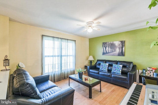 living room featuring light wood finished floors and ceiling fan