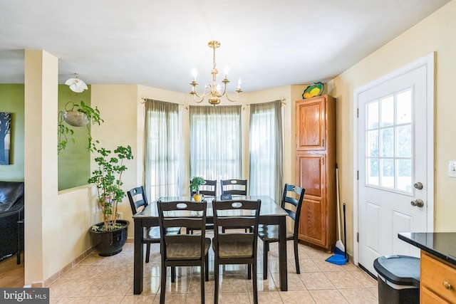 tiled dining area with a chandelier