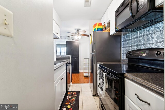 kitchen with white cabinetry, black appliances, light tile patterned flooring, and visible vents