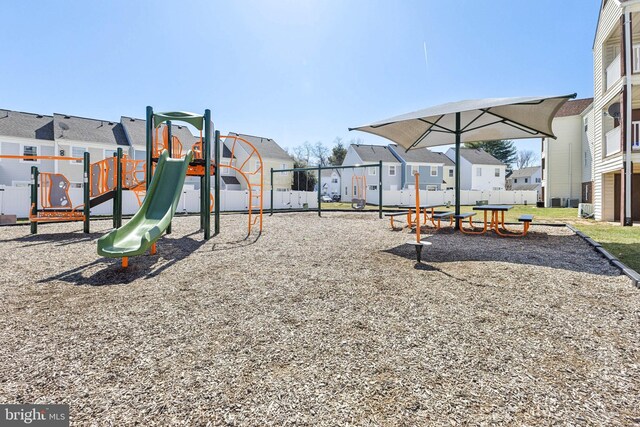 community playground featuring a residential view and fence