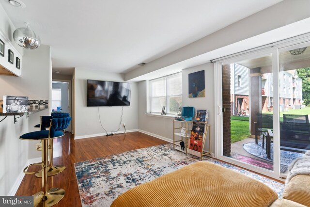 interior space featuring baseboards and wood finished floors