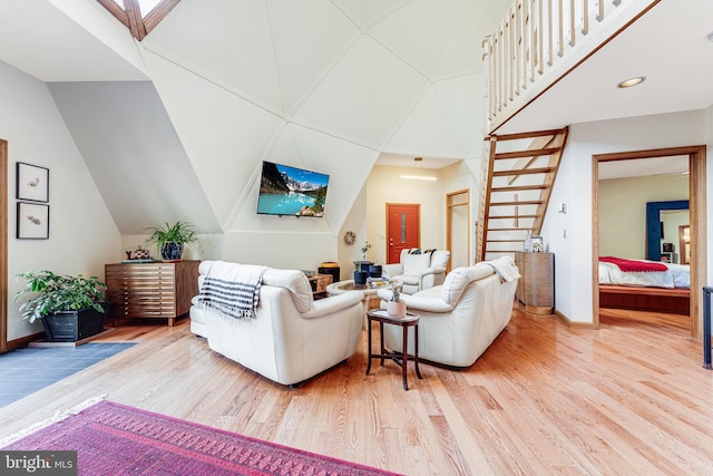 living room with vaulted ceiling and hardwood / wood-style flooring