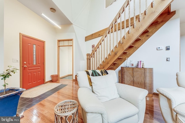 interior space featuring hardwood / wood-style flooring and a towering ceiling