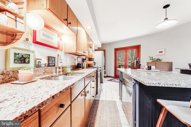 kitchen with light tile patterned floors, appliances with stainless steel finishes, pendant lighting, french doors, and sink