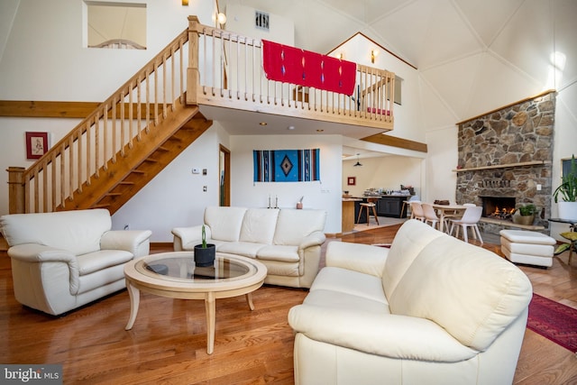 621 Paradise Hts, Oakland, MD 21550 - living area featuring stairway, wood finished floors, a stone fireplace, and a high ceiling
