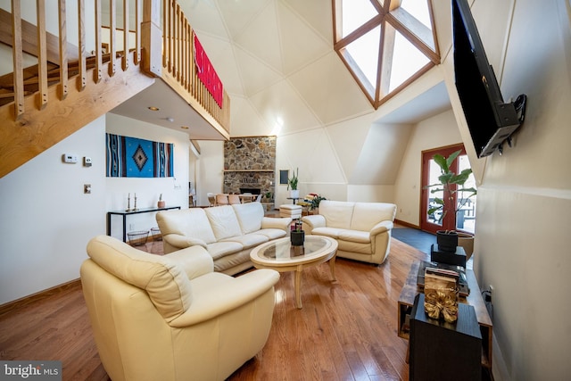 621 Paradise Hts, Oakland, MD 21550 - living room with a fireplace, a towering ceiling, hardwood / wood-style floors, and baseboards
