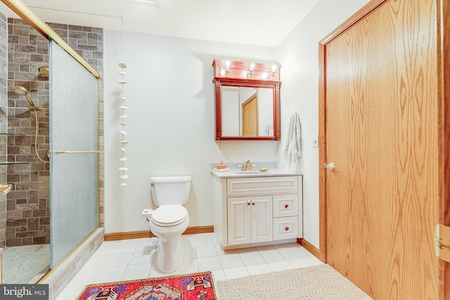 bathroom with vanity, toilet, tile patterned floors, and a shower with door