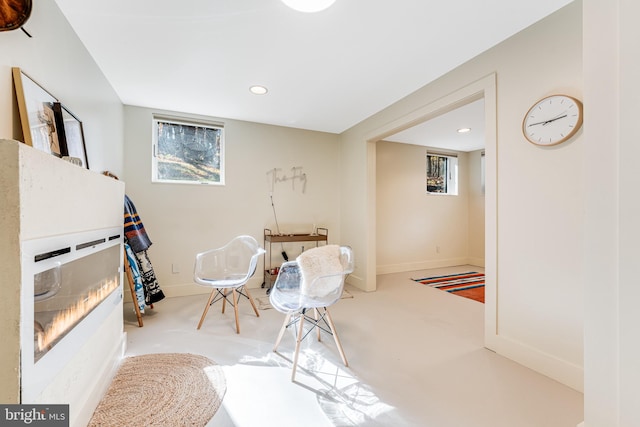 living area featuring light carpet