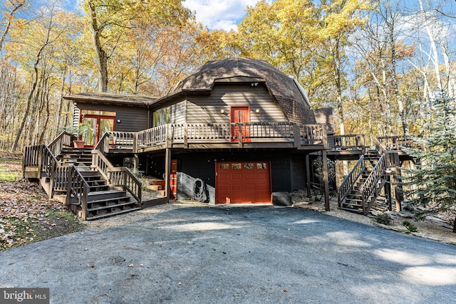 view of front of home featuring a wooden deck and a garage