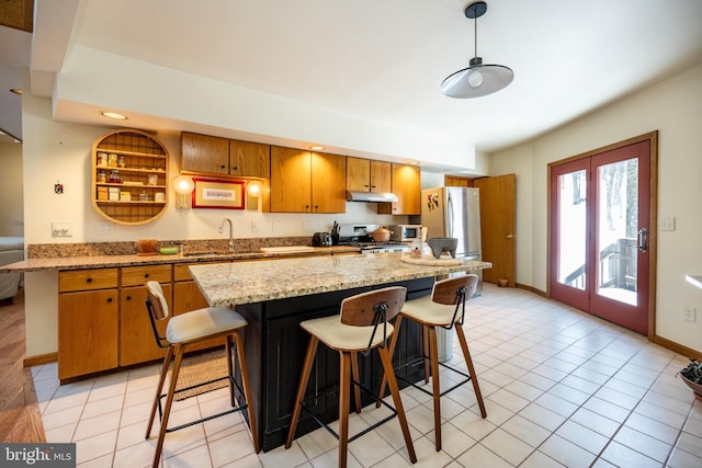621 Paradise Hts, Oakland, MD 21550 - kitchen featuring stove, freestanding refrigerator, under cabinet range hood, brown cabinets, and a sink