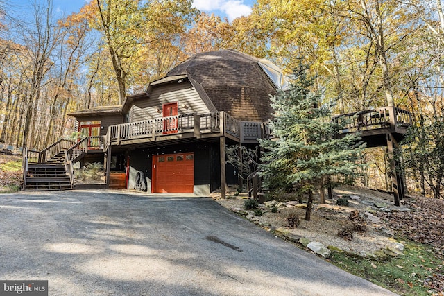 view of front of home featuring a deck and a garage