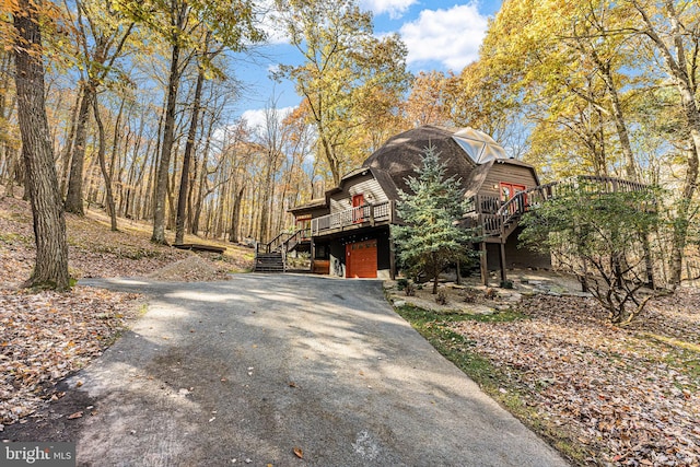 exterior space with a garage and a deck