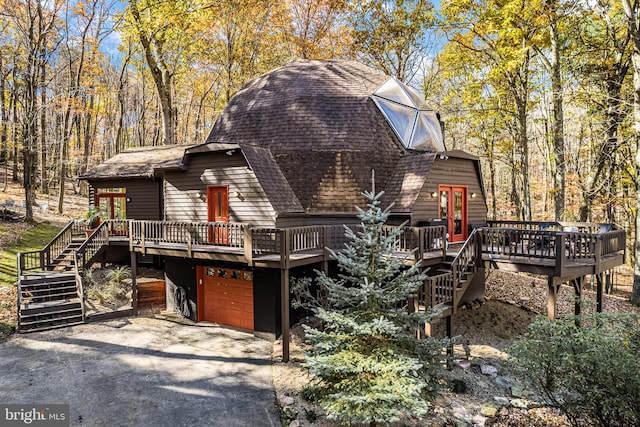 view of home's exterior with a deck and a garage