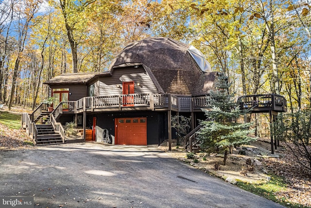 view of front of home featuring a wooden deck and a garage