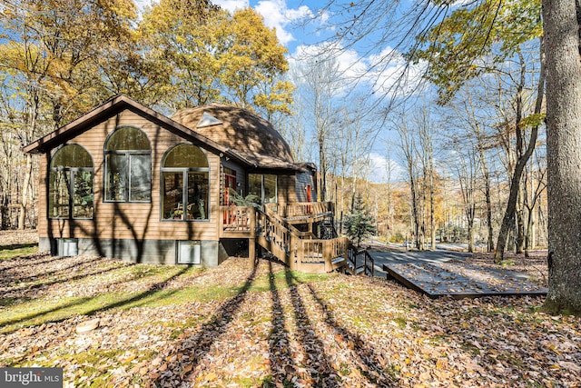 back of house featuring a wooden deck