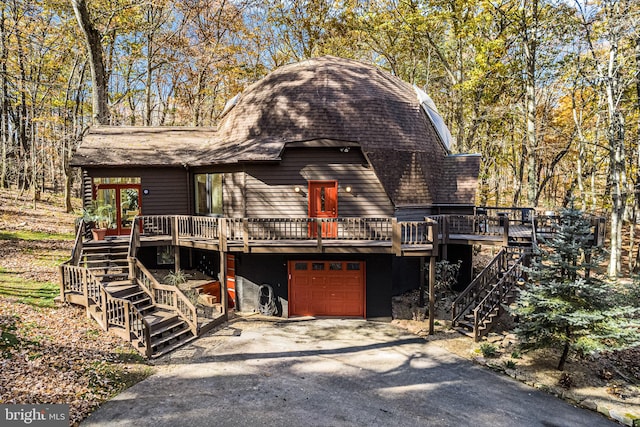 view of property with a wooden deck and a garage