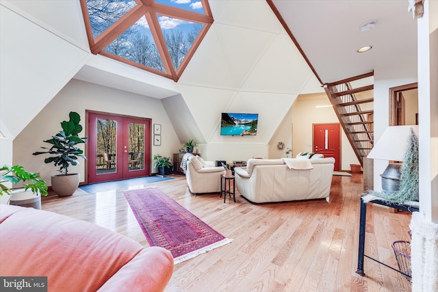 living room featuring french doors, hardwood / wood-style flooring, and vaulted ceiling