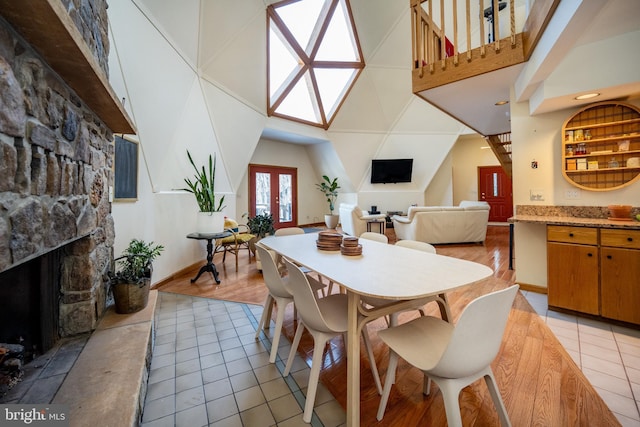 621 Paradise Hts, Oakland, MD 21550 - dining area featuring baseboards, high vaulted ceiling, light tile patterned floors, and a fireplace