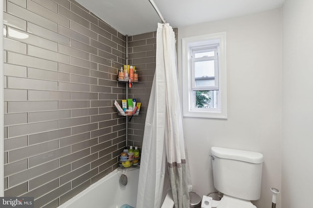 bathroom with toilet and shower / tub combo