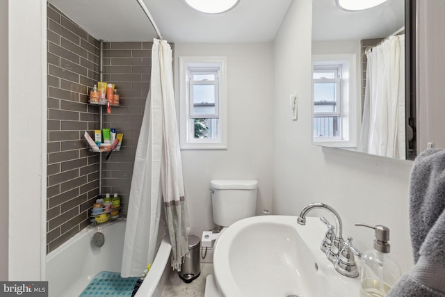 full bathroom featuring a wealth of natural light, sink, tile patterned floors, and shower / bathtub combination with curtain