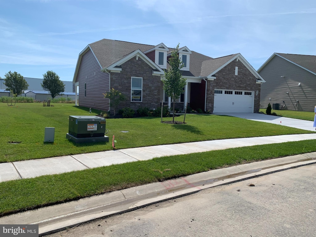 view of front of home featuring a garage and a front lawn