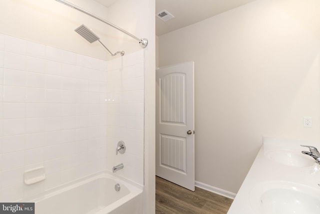 bathroom with vanity, shower / bathing tub combination, and hardwood / wood-style flooring