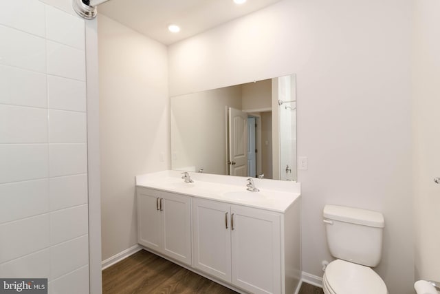 bathroom featuring hardwood / wood-style floors, vanity, and toilet