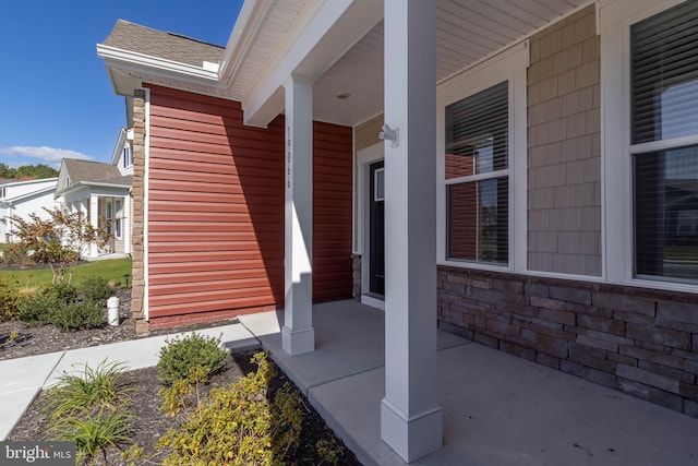 view of exterior entry with covered porch