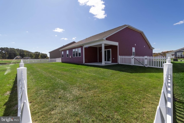 back of property featuring a yard and a patio area