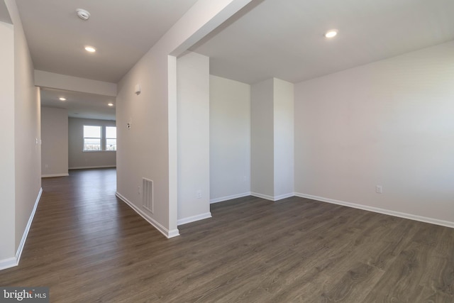 unfurnished room featuring dark wood-type flooring