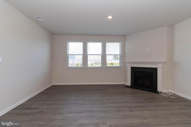 unfurnished living room with dark hardwood / wood-style floors