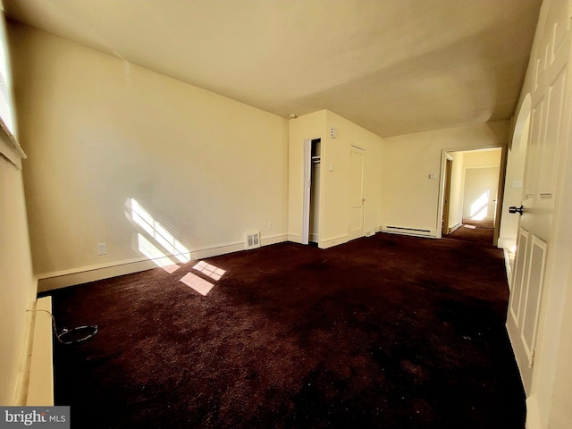 spare room featuring a baseboard heating unit