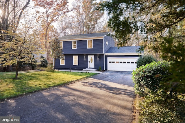 front of property featuring a garage and a front lawn