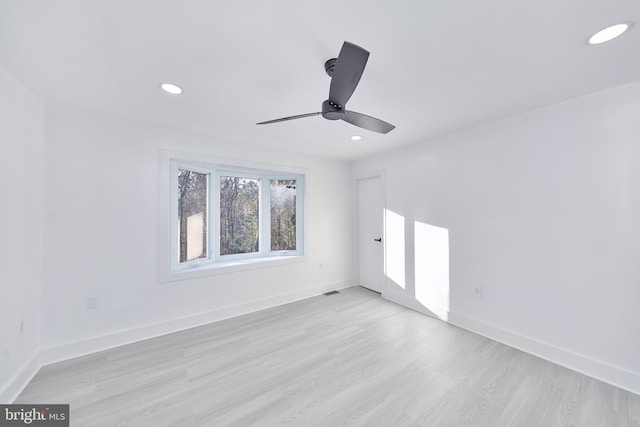 empty room with ceiling fan and light wood-type flooring