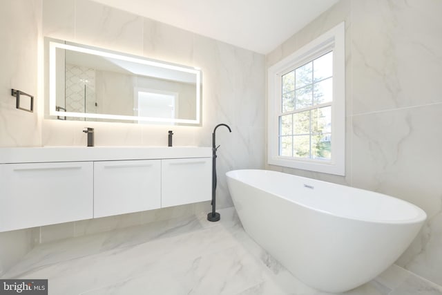 bathroom featuring tile walls, vanity, and shower with separate bathtub