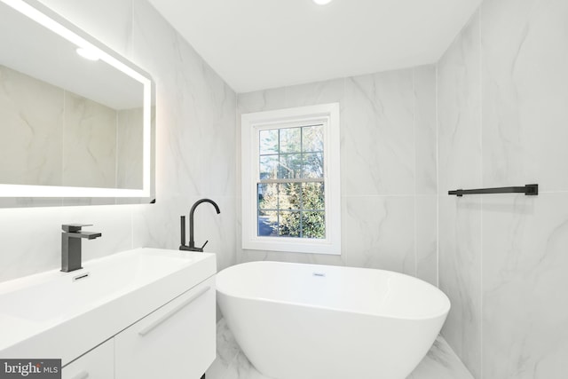 bathroom featuring a bath, tile walls, and vanity