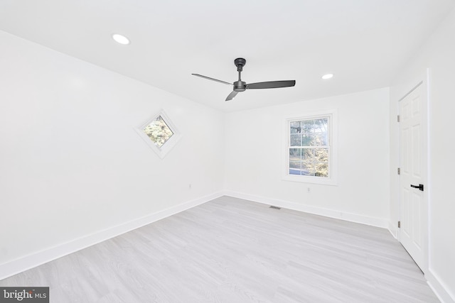 unfurnished room featuring light hardwood / wood-style floors and ceiling fan